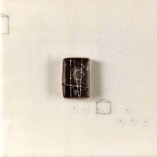 Remembering, an encaustic panel by Marn Jensen: a small dark box holding a tintype portrait, set in pale wax above tiny letter tiles spelling “Remember”